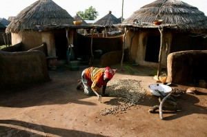 An accused witch in Gambaga arranges nuts (photo by Brian McAndrew)