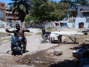 Baba, an Accra street vendor, in front of the lot where he sleeps.